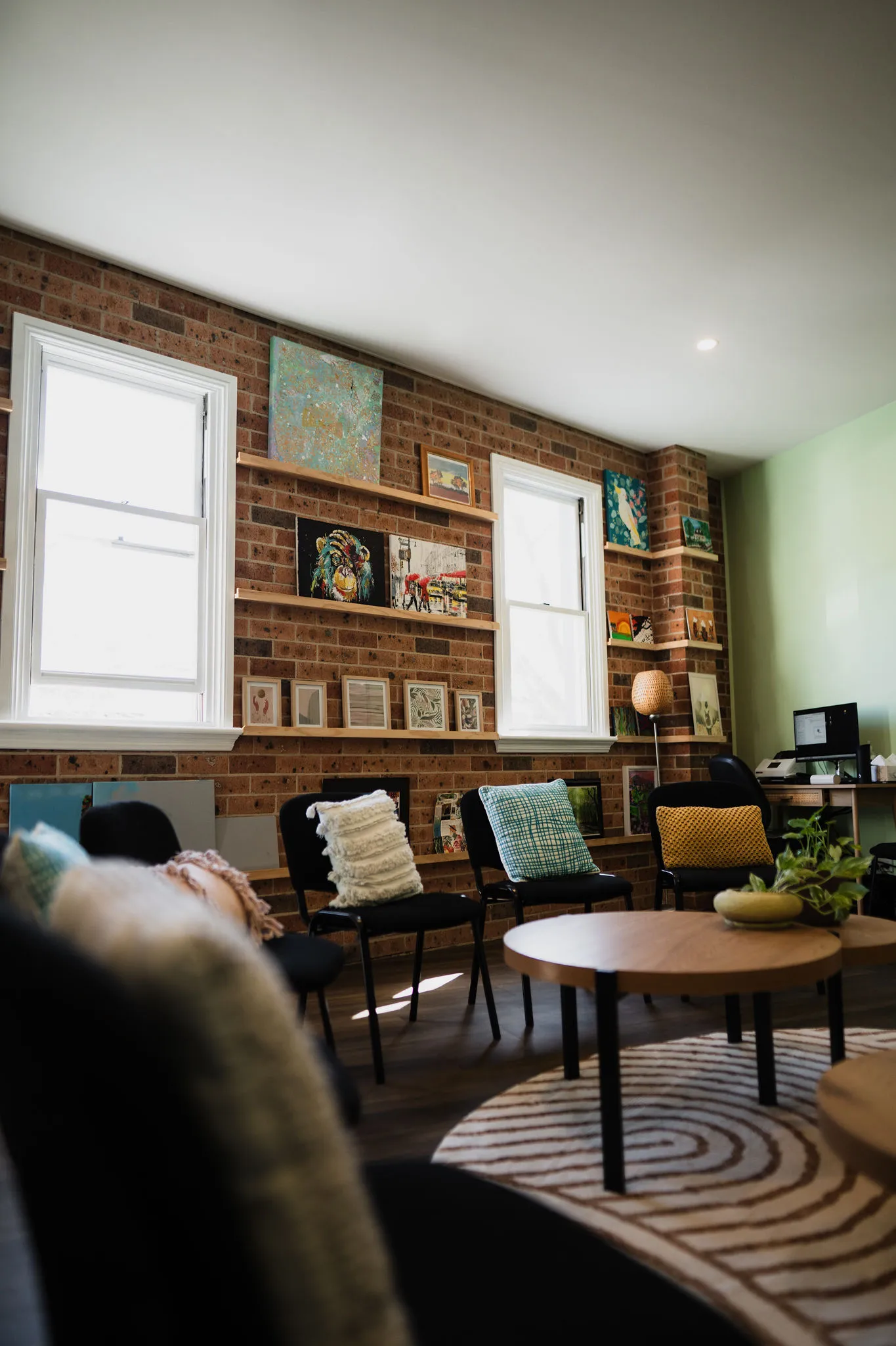 A warm, welcoming clinic waiting area with sage green walls and soft natural light