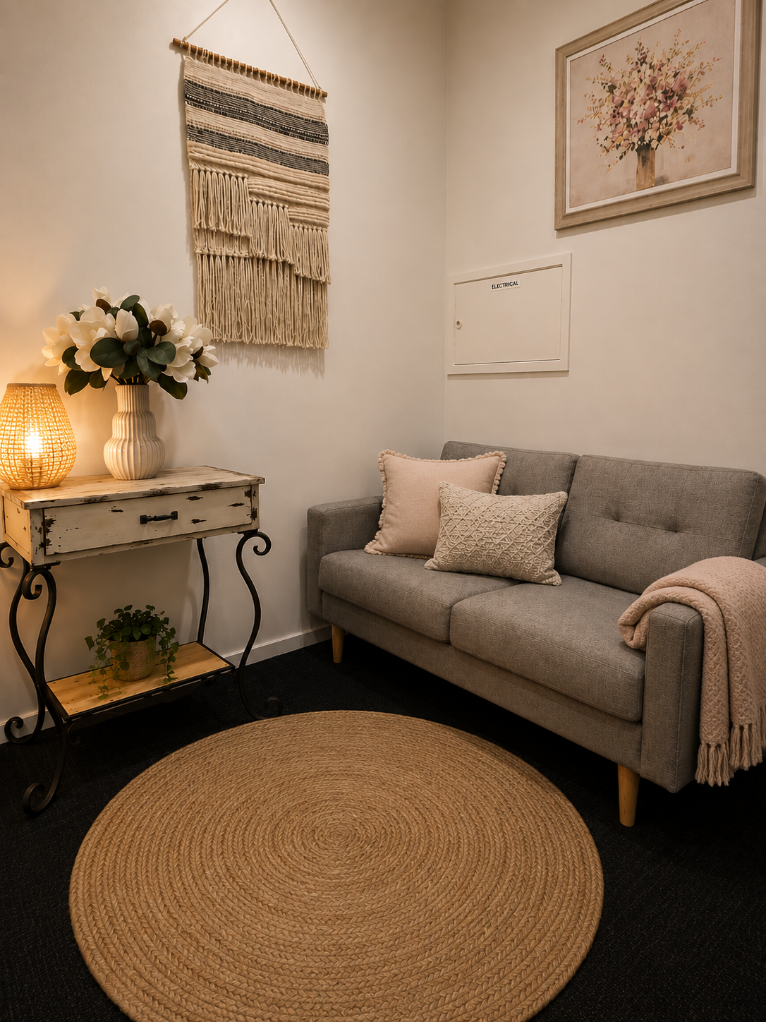 A calm, private therapy space with soft natural light and comfortable seating